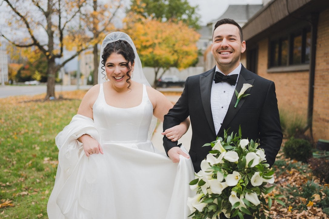 Delaney and her husband Sam laughing together on their wedding day